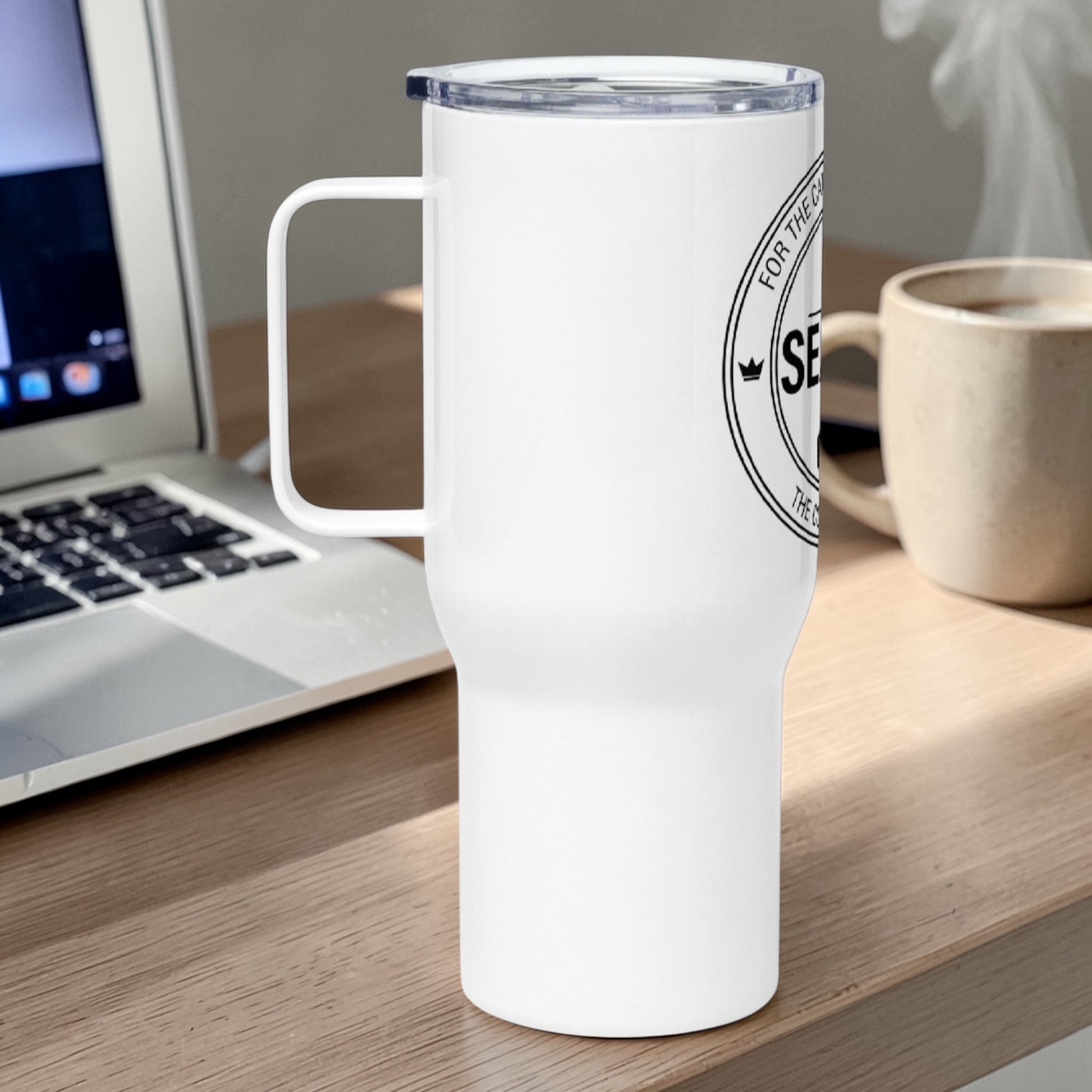 White 40 oz Christian travel mug with handle featuring partial SEALED Co. logo on desk beside laptop and coffee cup
